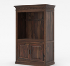 Black entertainment center with coffee-making equipment in a room with a chair and wall art.