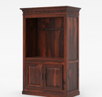 Black entertainment center with coffee-making equipment in a room with a chair and wall art.