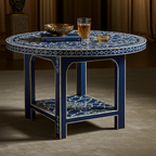 Decorative round table with blue and white patterned design, featuring a glass of amber liquid and a bowl on a dark background.