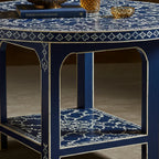 Blue and white patterned side table with decorative items on a neutral background