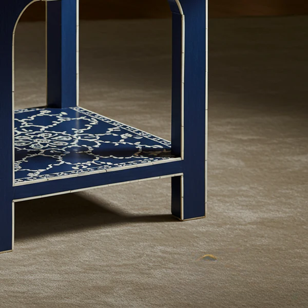 Blue chair with a patterned seat on a gray floor