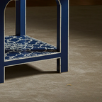 Blue chair with a patterned seat on a gray floor